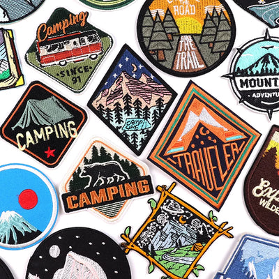 Collection of camping-themed patches on a white background