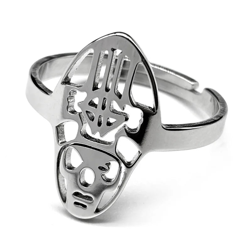 Silver ring featuring an abstract, tribal mask design with cutout details. The ring has a smooth, polished finish and modern, artistic style.