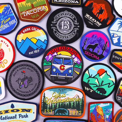 Collection of various travel-themed patches on a white background