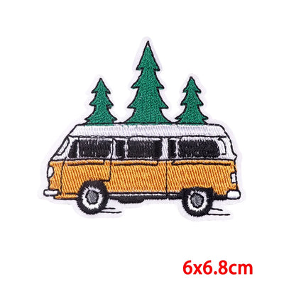 Embroidered patch of a camper van with trees on a white background