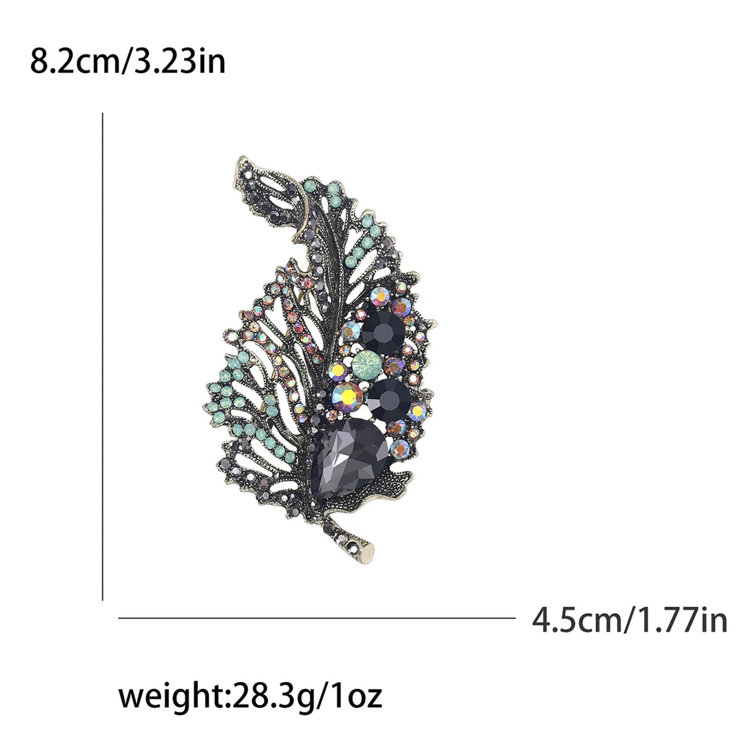 Decorative brooch with gemstones and measurements on a white background