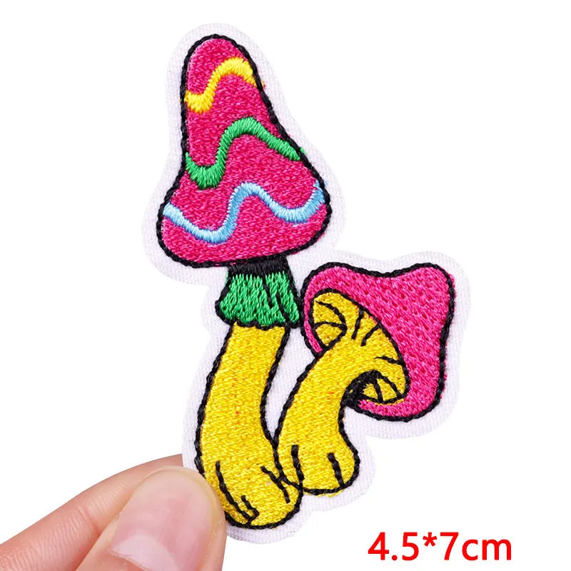 Colorful cartoon-style patch with feet and a hat held by a hand on a white background.