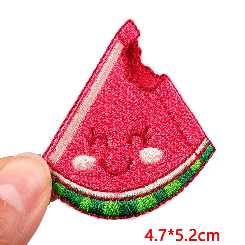 Embroidered watermelon patch held by a hand with dimensions displayed.