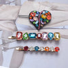 Colorful gemstone hair clips on a light background