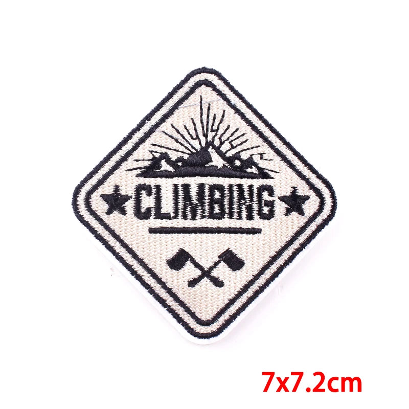 Climbing patch with mountain and axes design on a white background