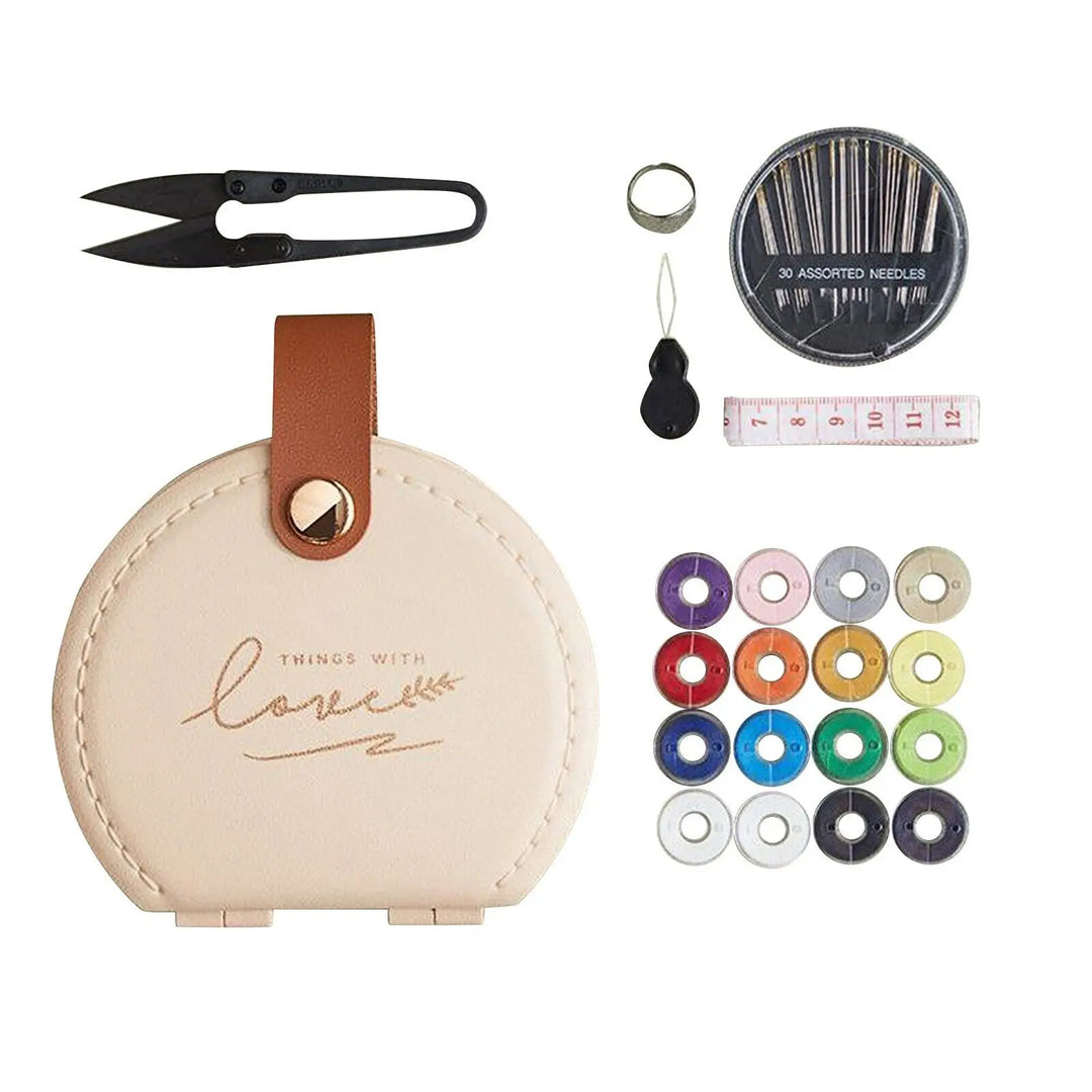 Sewing kit with apricot/beige case, scissors, needles, thread, and measuring tape on a white background