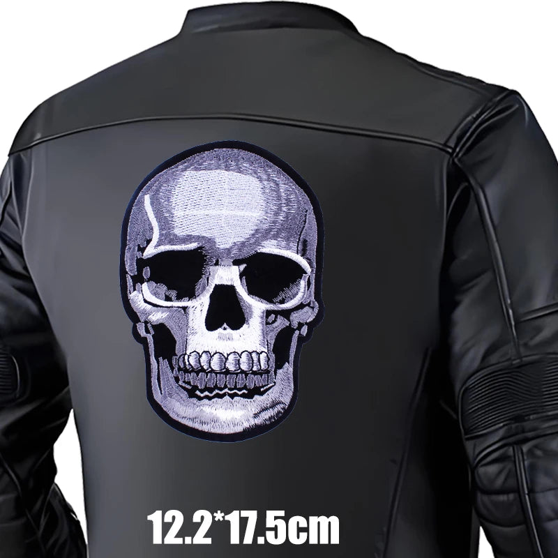 Black leather jacket with a skull design on the back, size indicated.