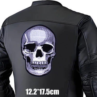 Black leather jacket with a skull design on the back, size indicated.