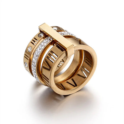 Gold ring with Roman numeral design and embedded diamonds on a white background