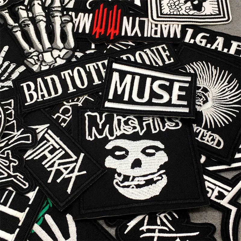 Collection of various patches with different designs and text on a black background