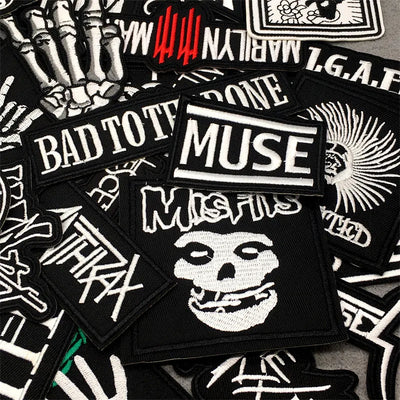 Collection of various patches with different designs and text on a black background