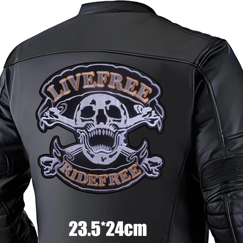 Black leather jacket with skull and crossbones design and 'Live Free Ride Free' text on a white background.