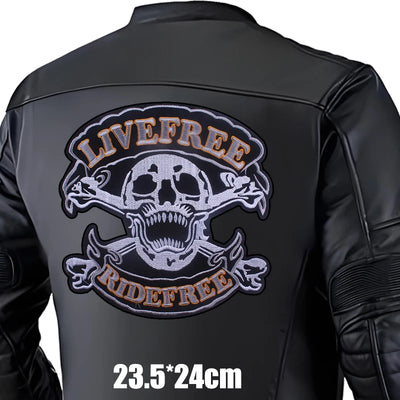 Black leather jacket with skull and crossbones design and 'Live Free Ride Free' text on a white background.