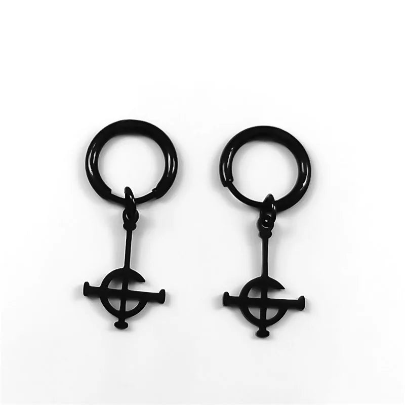 Pair of black earrings with circular top and cross-like bottom on a white background