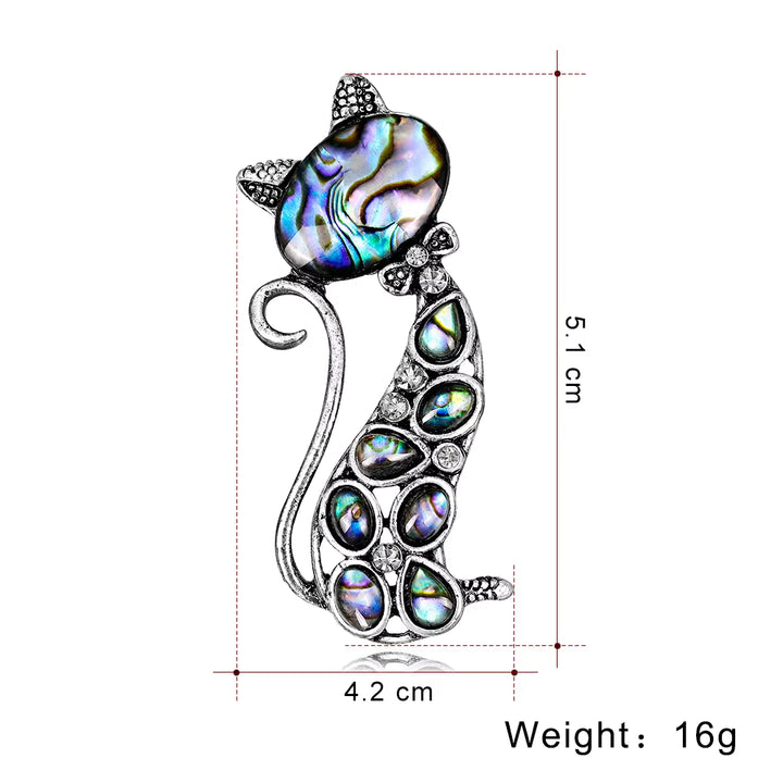 Cat-shaped brooch with abalone shell inlay and measurements on a white background