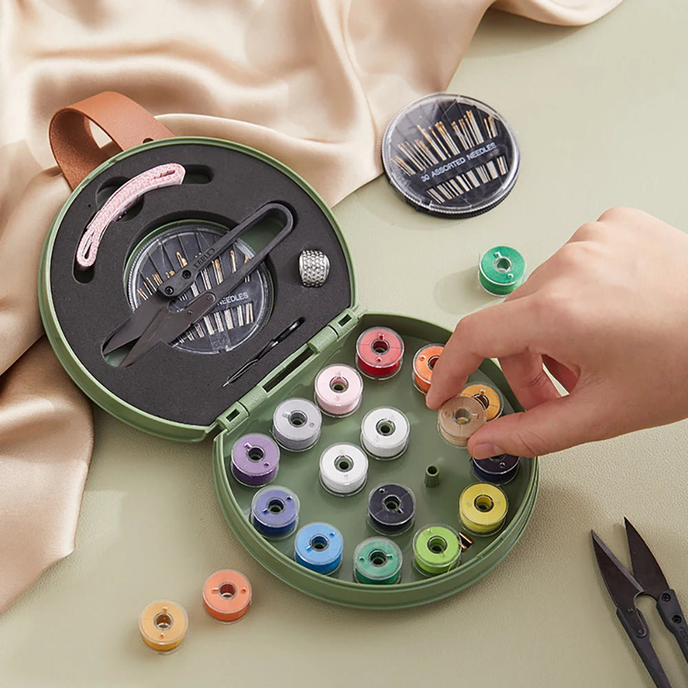 Green sewing kit with colorful thread spools on a light surface