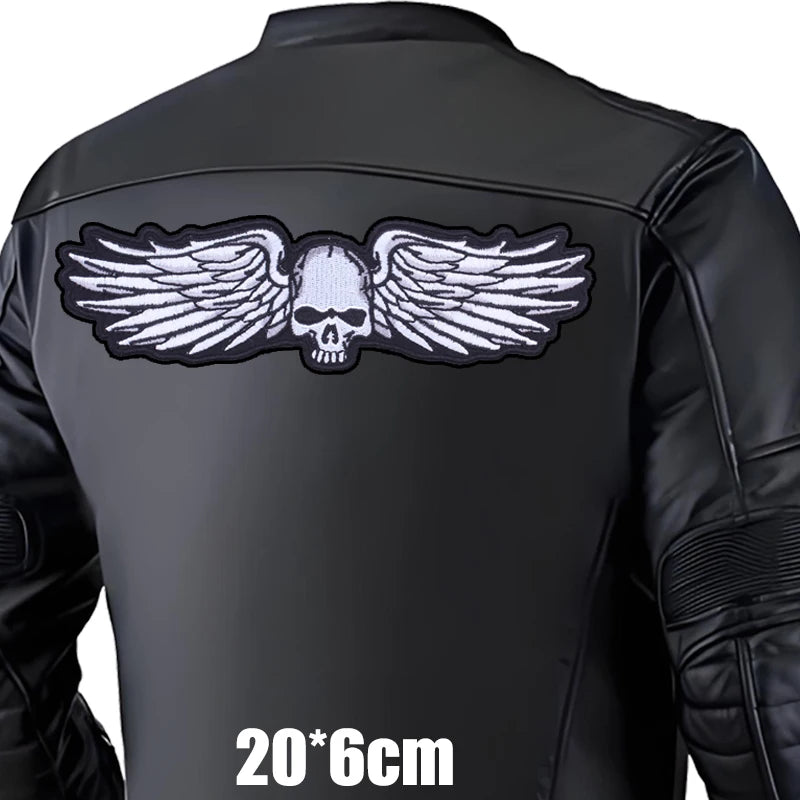 Black leather jacket with a skull and wings design on the back, on a white background.