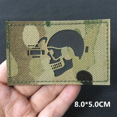 Green tactical patch with skull and microphone design held in hand