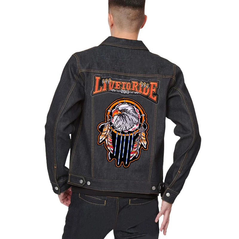 Black denim jacket with 'Live to Ride' and eagle design on the back, worn by a person.