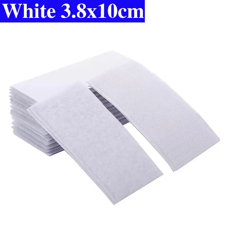 Stack of white Velcro pads with dimensions 3.8x10cm on a white background