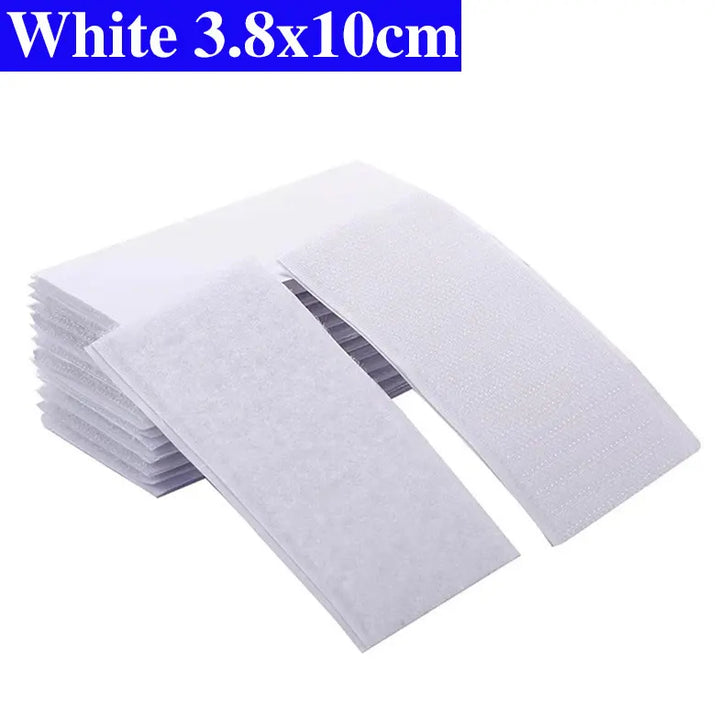 Stack of white Velcro pads with dimensions 3.8x10cm on a white background