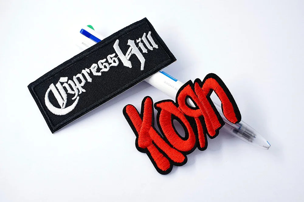 Patch with 'Cypress Hill' logo and red 'Korn' text on a white background