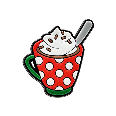 Shoe charm ornament of a red polka dot mug with whipped cream and a spoon on a white background