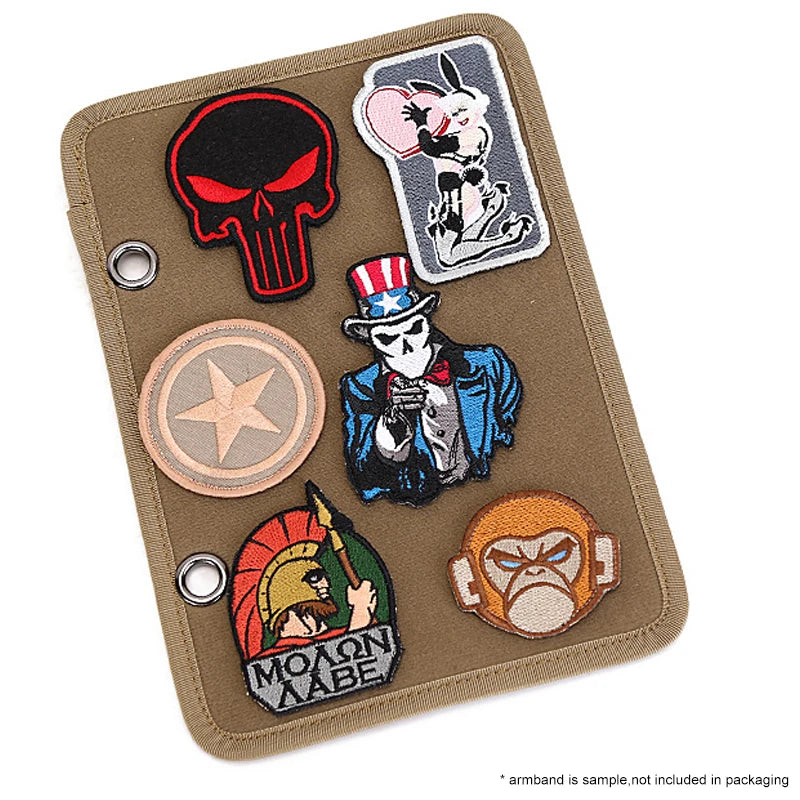 Collection of various patches on a brown Tactical patch display panel on a white background