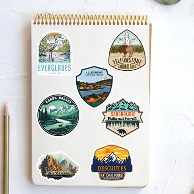 Notebook with national park stickers on a white surface