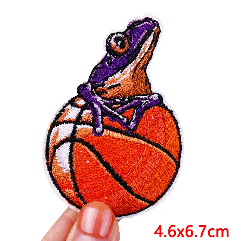 Patch of a frog on a basketball held by a hand with measurement &