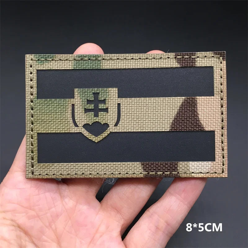 Slovakia flag Camouflage patch held in a hand against a dark background