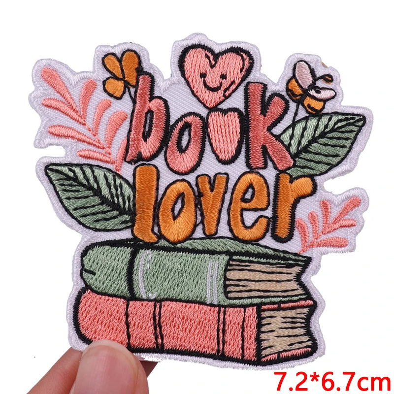 Embroidered patch with 'book lover' text and book design on a white background