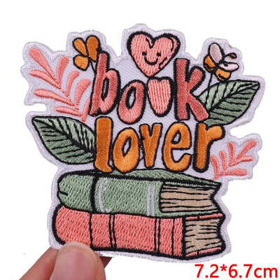 Embroidered patch with 'book lover' text and book design on a white background