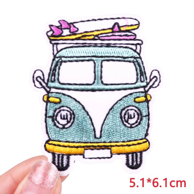 Embroidered patch of a van with surfboards on a white background