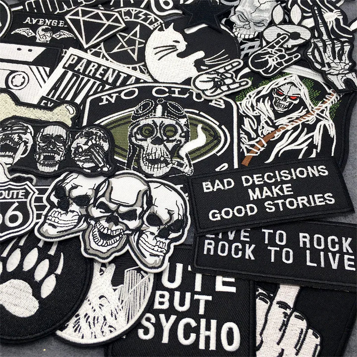 Collection of various black and white patches with text and graphics on a black background