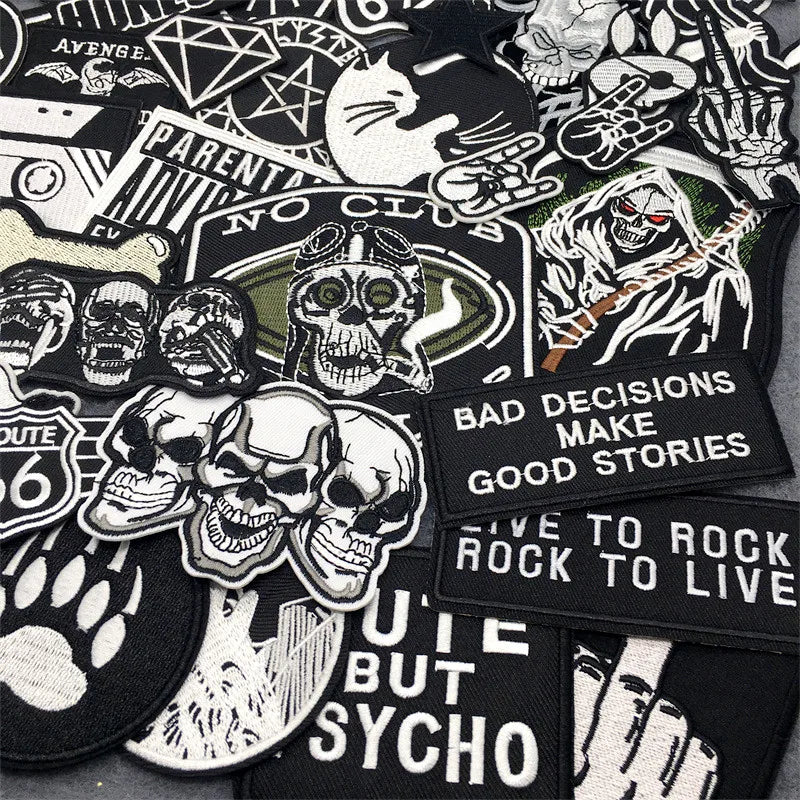 Collection of various black and white patches with text and graphics on a black background