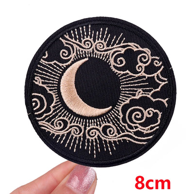 Circular patch with crescent moon design held by a hand, size indicated as 8cm.