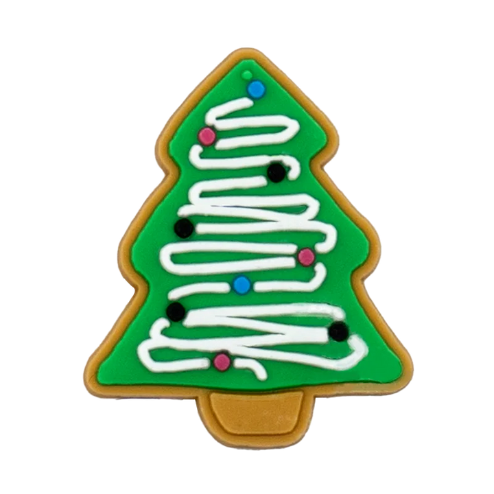 Shoe charm ornament of Christmas tree-shaped cookie with green background, white icing, and colorful decorations on a white background