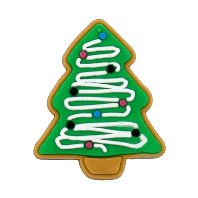Shoe charm ornament of Christmas tree-shaped cookie with green background, white icing, and colorful decorations on a white background
