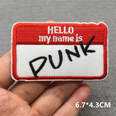 Name tag patch with 'HELLO my name is PUNK' text held in a hand against a gray background.