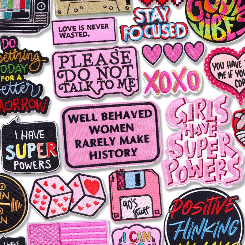 Collection of colorful patches with various phrases and designs on a white background