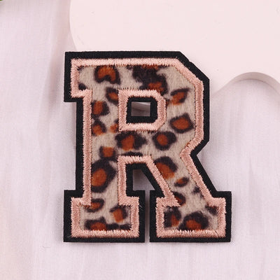 Leopard print letter 'R' patch on a white background