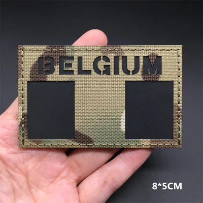 Belgium flag Camouflage patch  held in a hand against a dark background