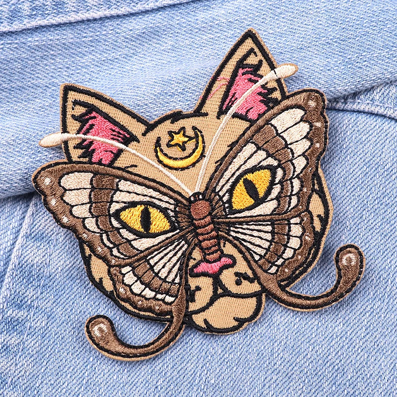Butterfly cat patch on a denim background