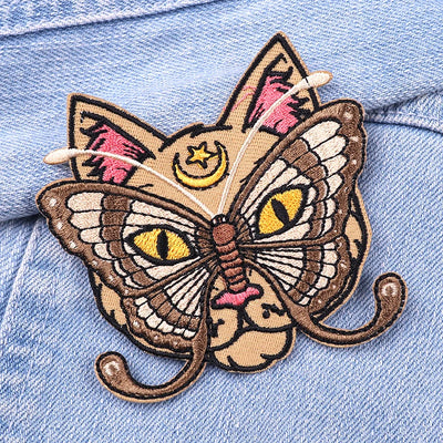 Butterfly cat patch on a denim background
