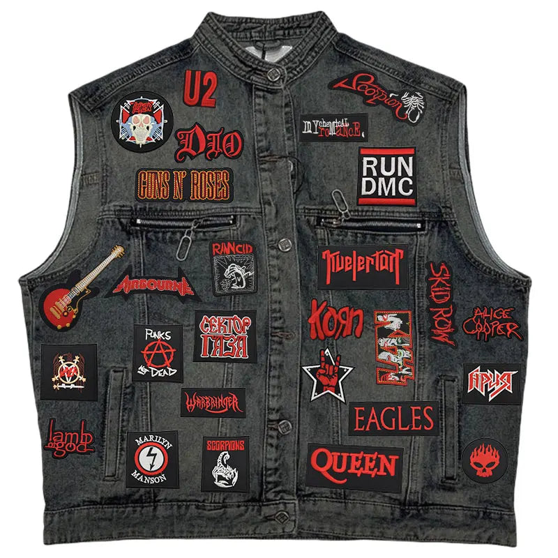 Black denim vest with various band patches on a white background