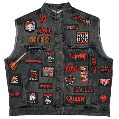 Black denim vest with various band patches on a white background