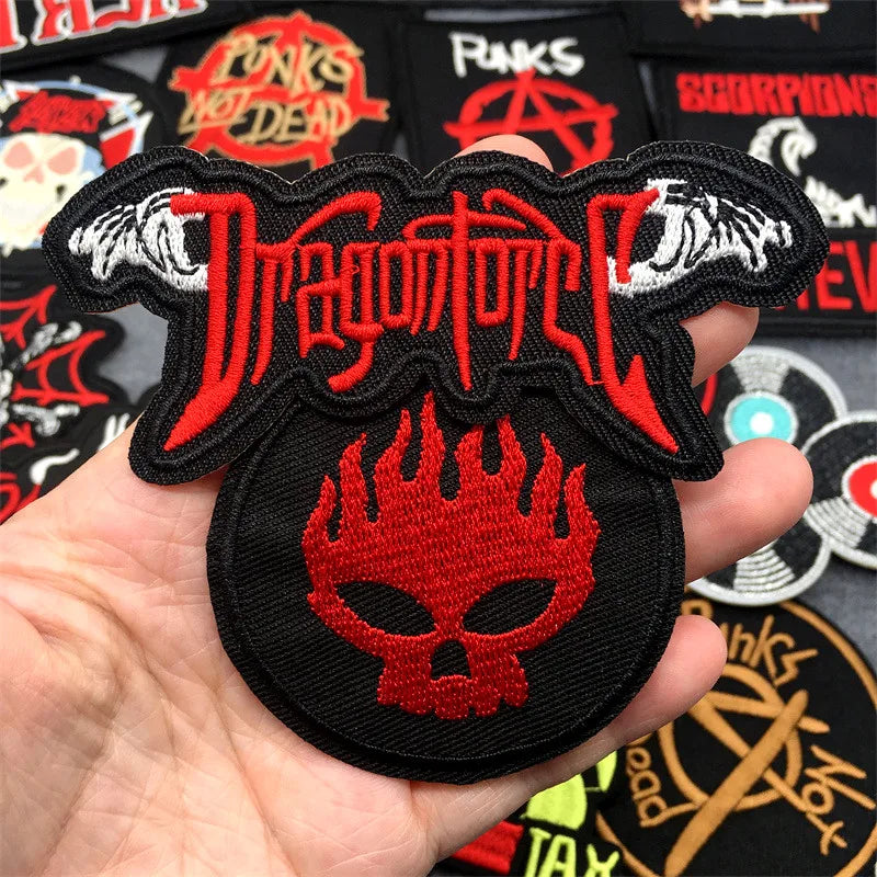 Dragonforce patch held in a hand with other patches in the background