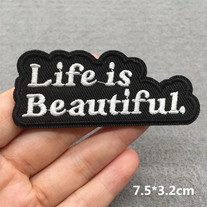 Embroidered patch with &