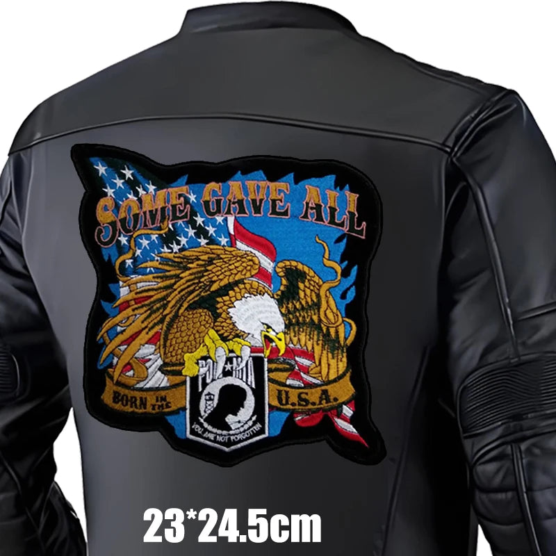 Black leather jacket with a colorful patch on the back featuring an eagle and text.